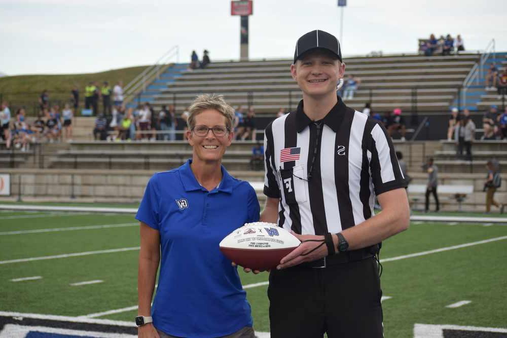 Dr. Heather Gulgin Hands Over the Game Ball Spotlight